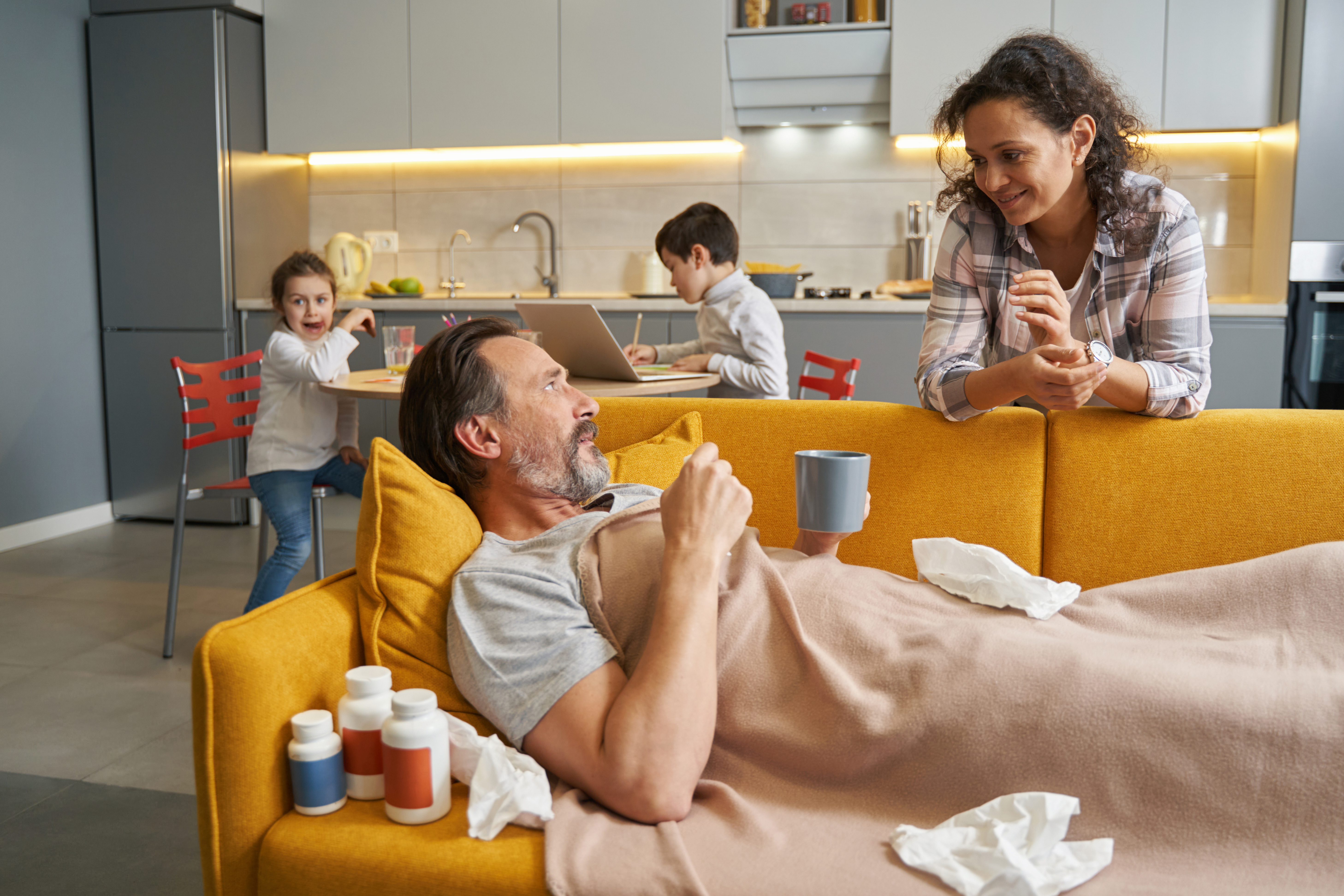 Caring family looking after a recovering man at home