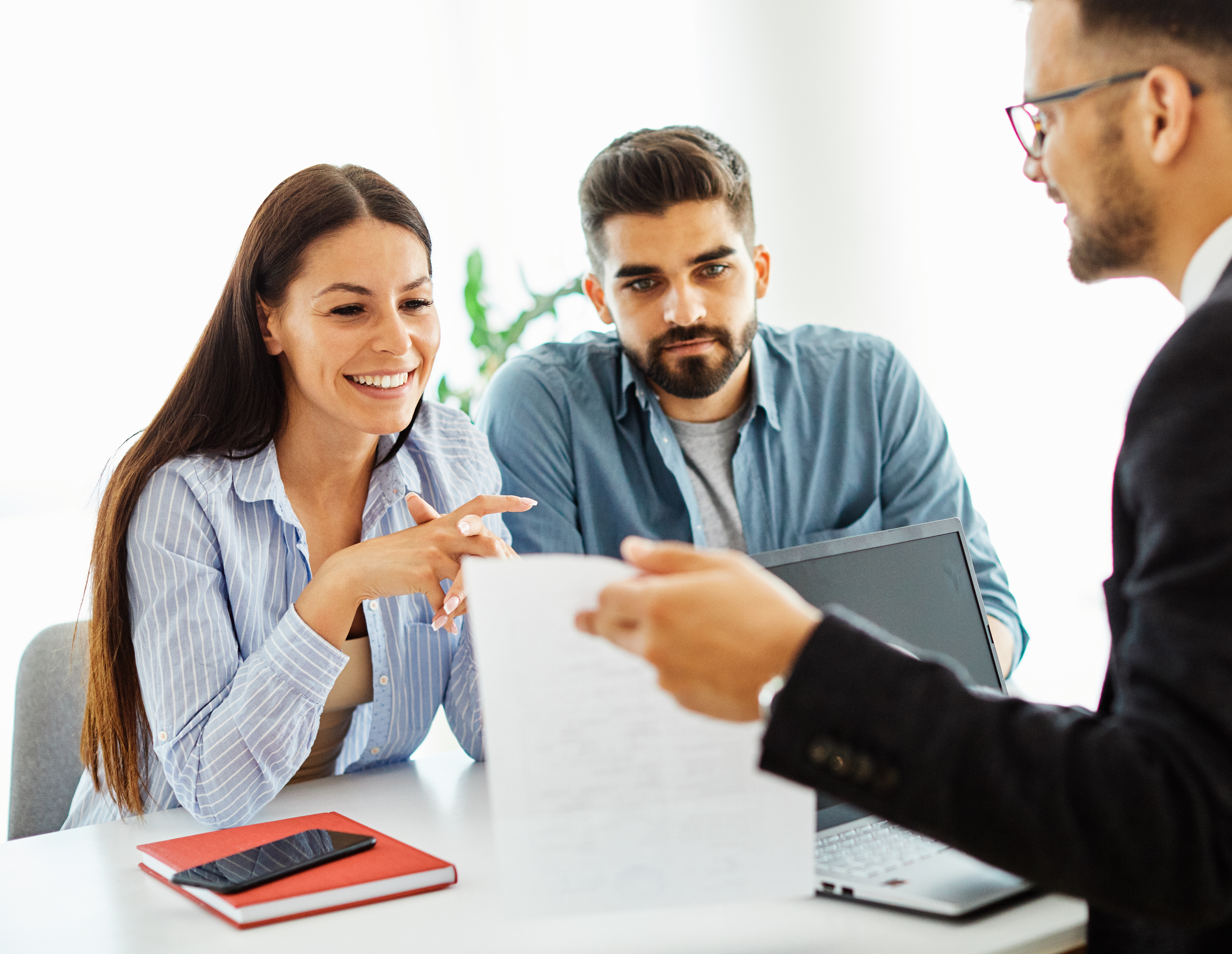 Couple meeting with an insurance professional in an office